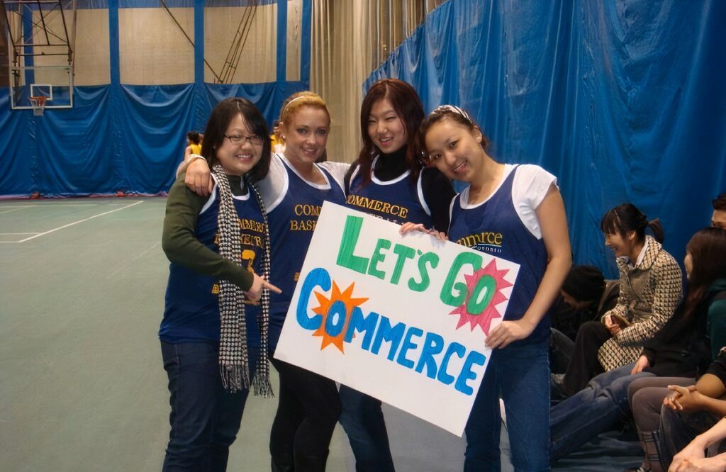 Students with "Let's Go Commerce" banner