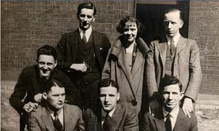 Black and white photo of seven people.
