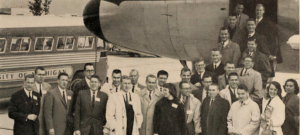 A group of students in front of a landed airplane