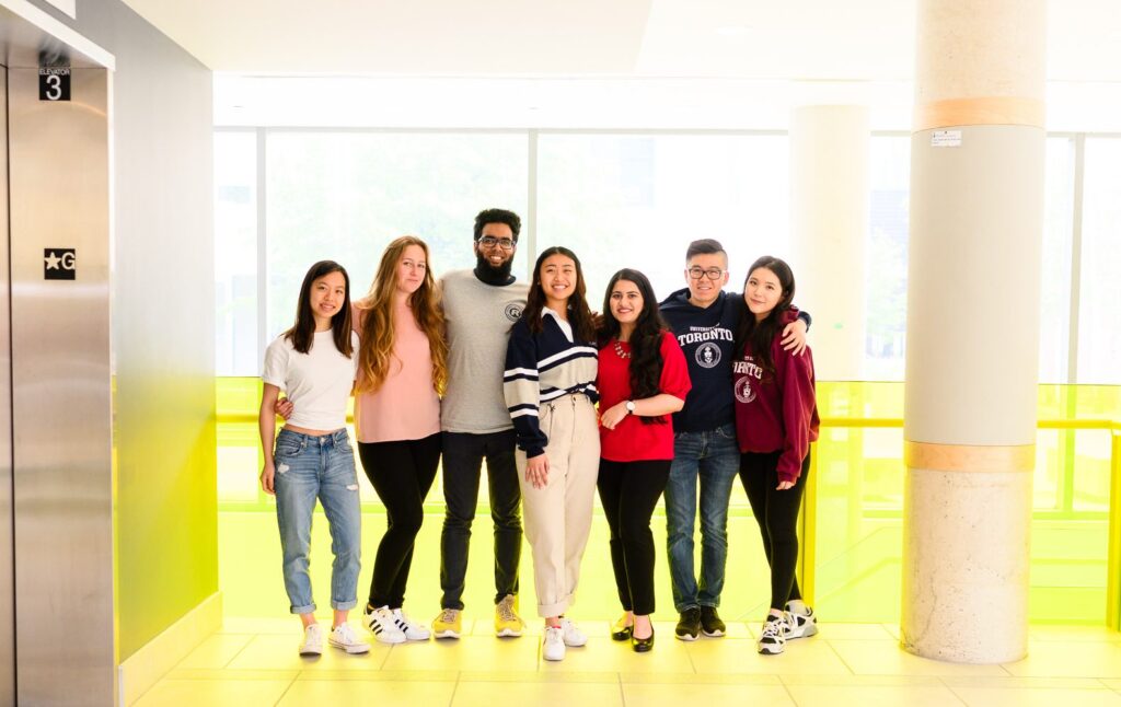 A diverse group of people standing together and smiling.