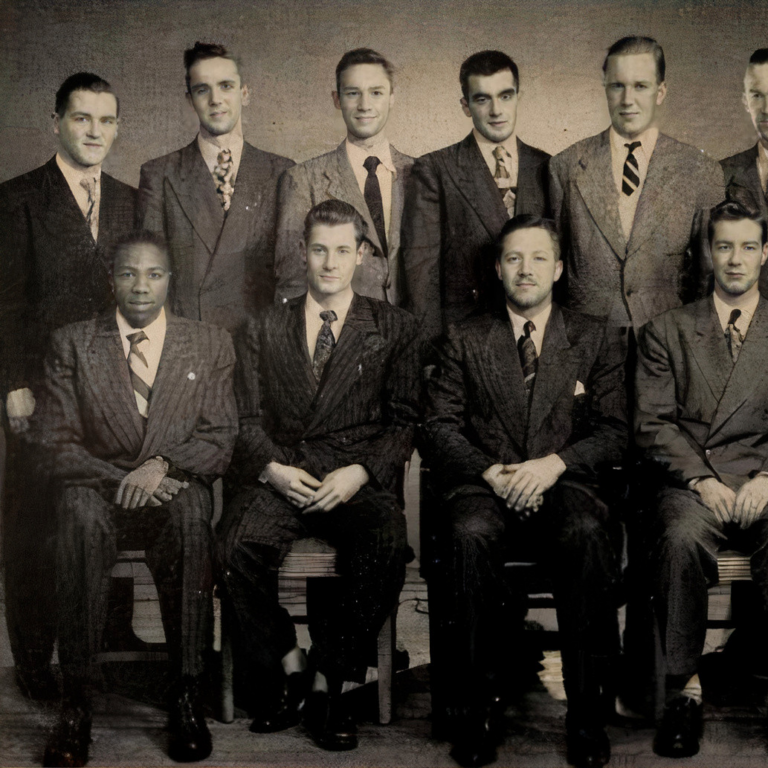 Black and white photo of a group of men dressed in suits.