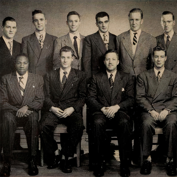 Black and white photo of a group of men dressed in suits.